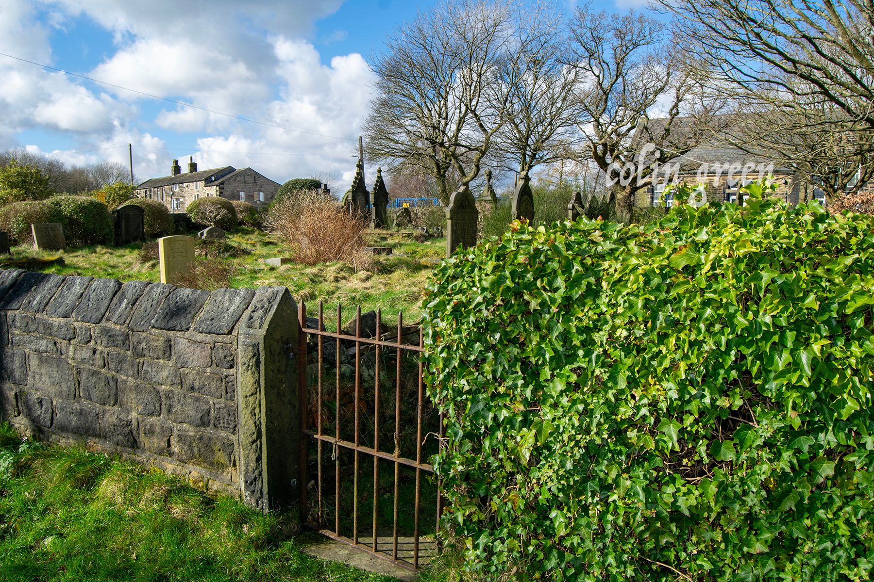 The rusty gated entrance to the churchyard at St Luke's Norland.