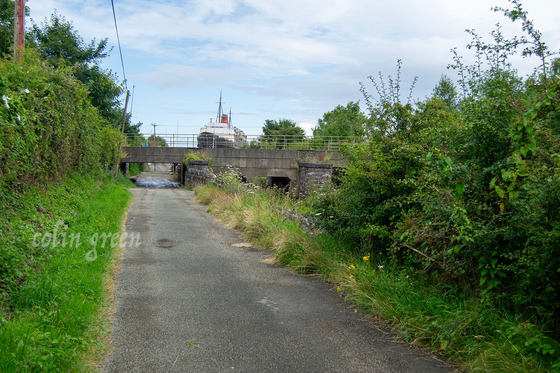 An image showing the road down towards the Dukes of Lancaster Ship, the railway bridge in the foreground.