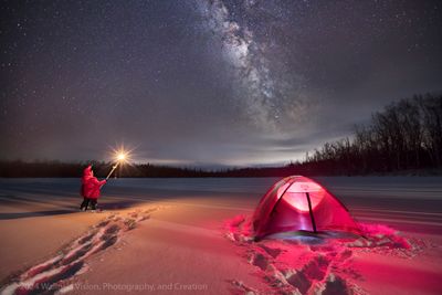 Amidst the serene frozen landscape of Lake Hennepin, Minnesota, I crafted a triangular tale of light and wonder. On the right, my red tent stood like a beacon, aglow with an inner light. Venturing into the knee-deep snow on the left, I raised a torch Tiki light towards the star-studded sky, as if guiding the Milky Way's celestial path. The resulting composition weaves a narrative of adventure, solitude, and connection to the vast, starry expanse.