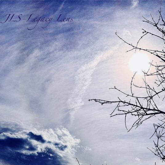 The Sun, a contrail and clouds