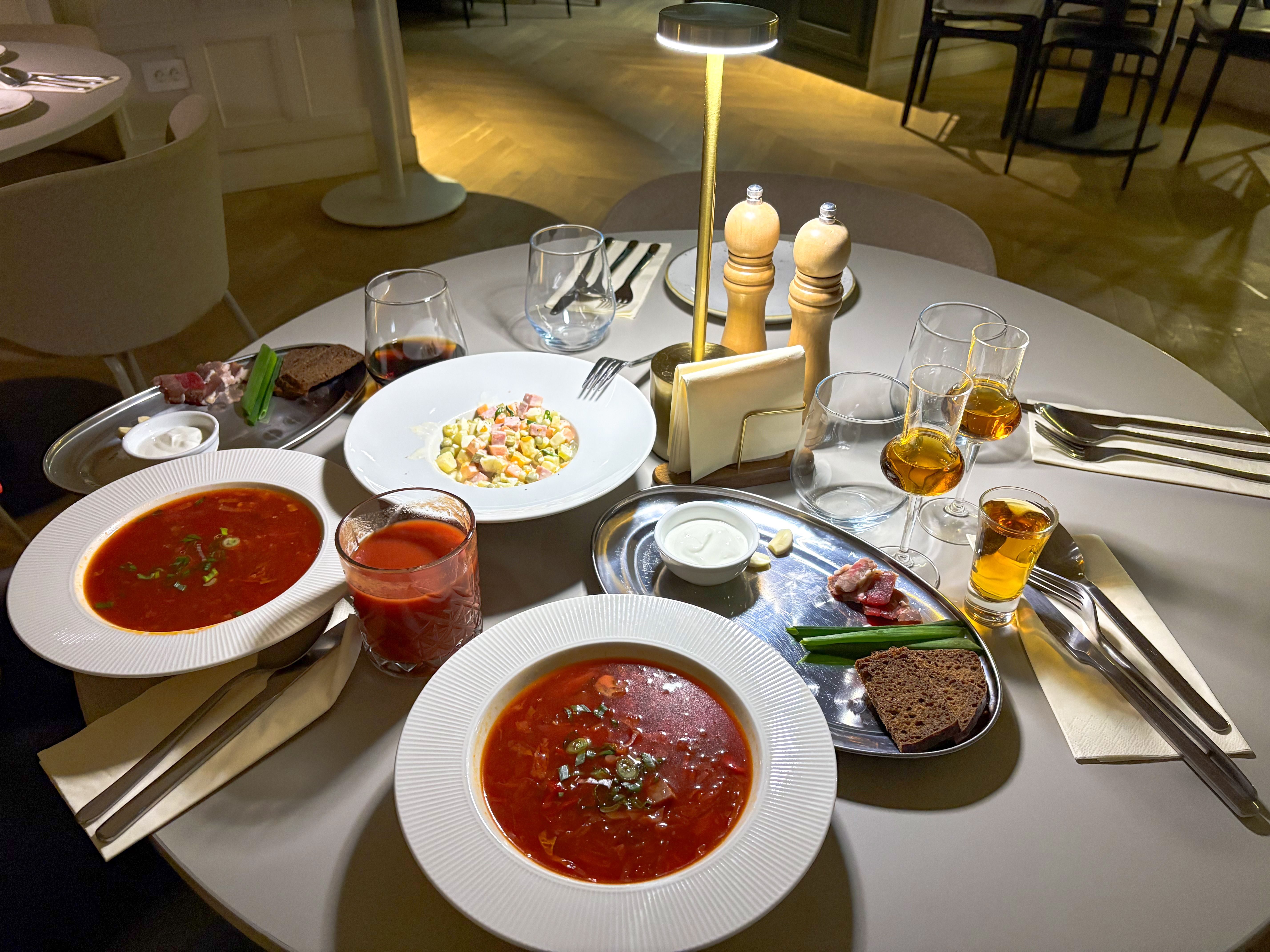 A restaurant table set with traditional Eastern European dishes by ...